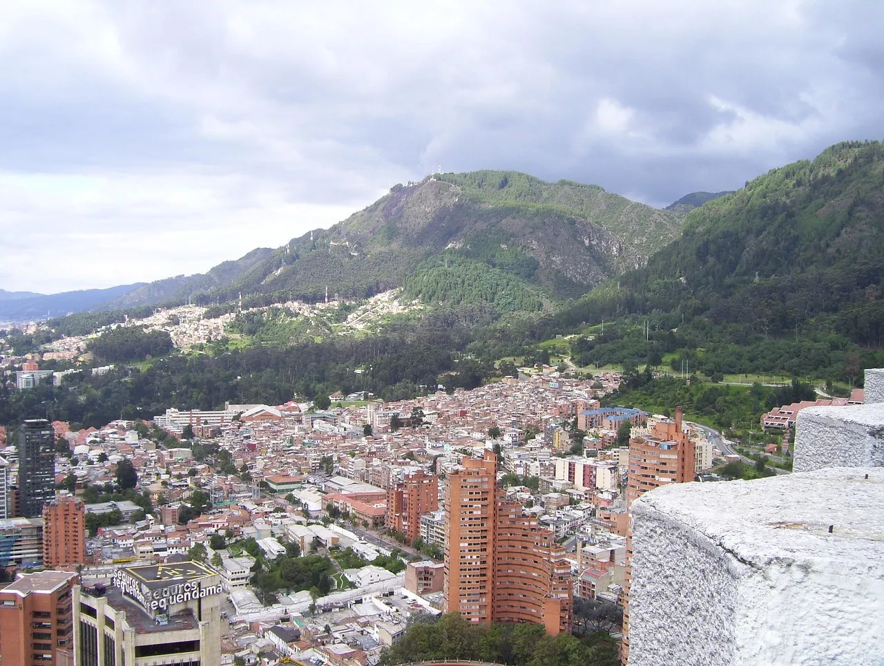 Viviendas de ladrillo rojo que suben por los cerros en el borde de la ciudad