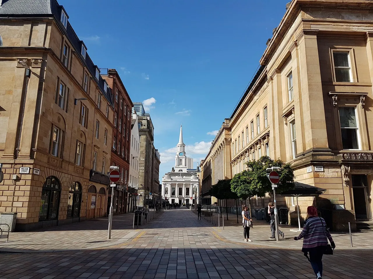 Sandstone buildings along a pedestrian street