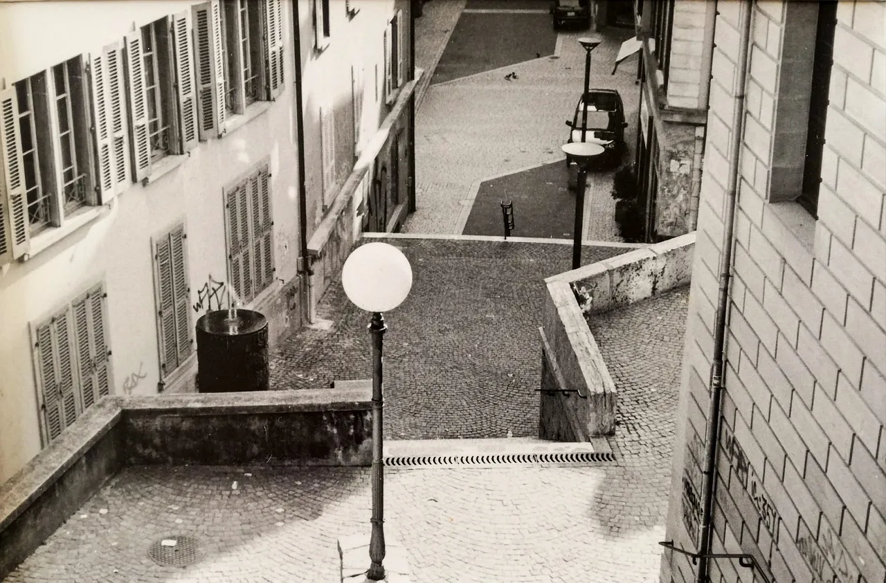 Steps and a lamp between old houses